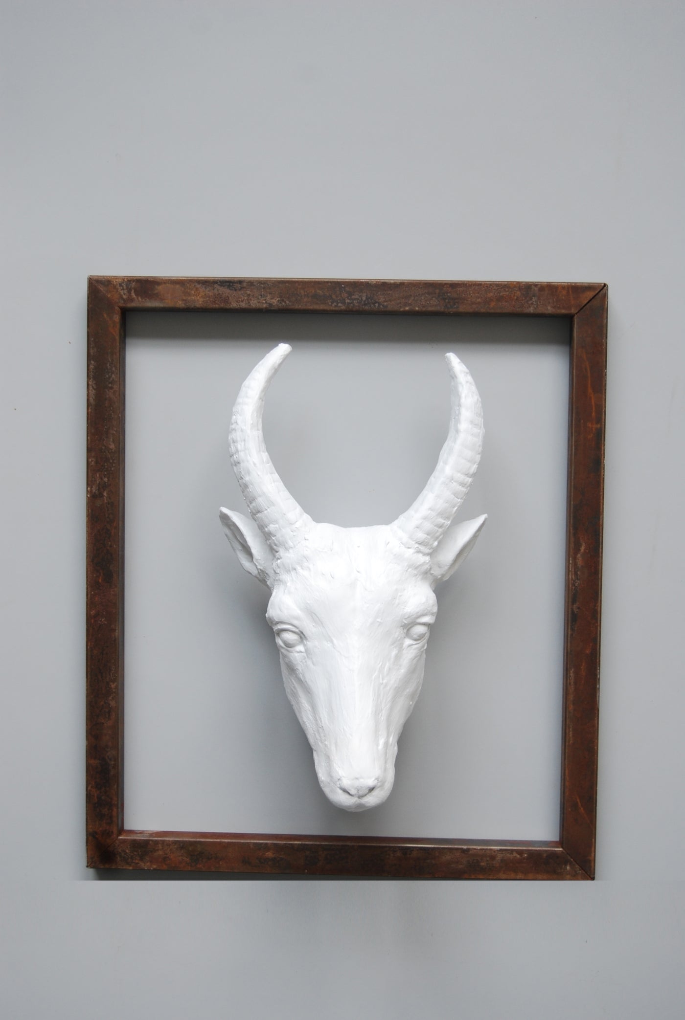 Metal frame with white Resin goat